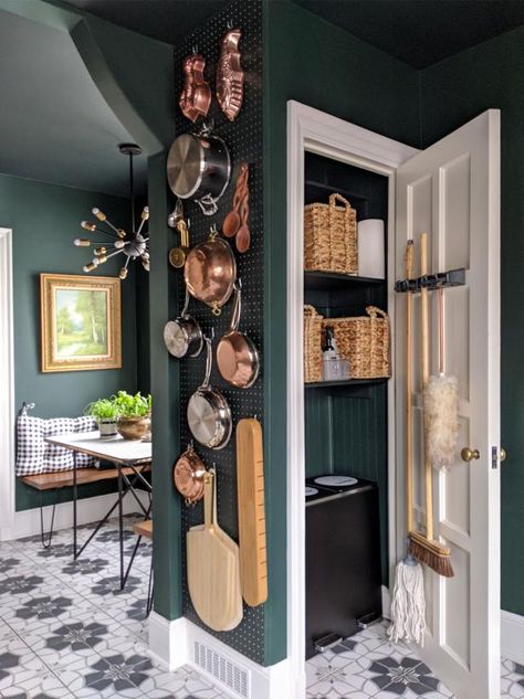 A narrow wall in the decorator’s home in Des Moines, Iowa, found its calling when it got a pegboard. “I have pans within reach and vintage treasures up top,” says Ruthie Jackson (@miracleonthirtyfourth). She had a pro who was working on her kitchen frame a pegboard, then Ruthie painted it the same color as the walls (Black Forest Green by Benjamin Moore). Hot tip: “If paint builds up in the holes, clear them with cotton swabs or you won’t be able to push in S-hooks.” Pegboard Organization Ideas, Pegboard Kitchen, Kitchen Organization Ideas, House Storage, Pegboard Organization, Closet Kitchen, Modern French, Up House, Peg Board