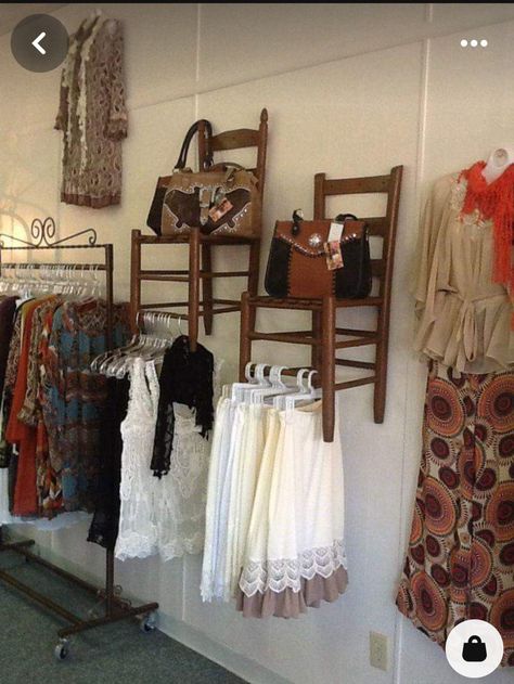 Face Out Clothing Display, Chair On Wall Display, Bohemian Storage Ideas, How To Display Purses In Boutique, Chairs On Wall Display, Chairs Hung On Walls, Vintage Clothing Rack Display, Purse Display Boutique, Antique Booth Clothing Display