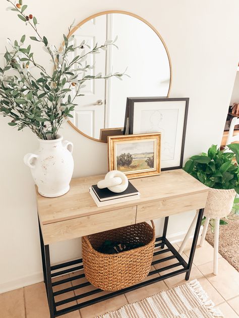 Simple and affordable entryway decor.  Modern wood and metal console table. Round gold mirror. Woven basket. Plant stand. Faux greenery.  Artwork. Hallway Table Decor, Rustic Entryway Table, Console Table Styling, Console Table Decorating, Entryway Table Decor, Entrance Table, Foyer Design, Entryway Ideas, Table Styling