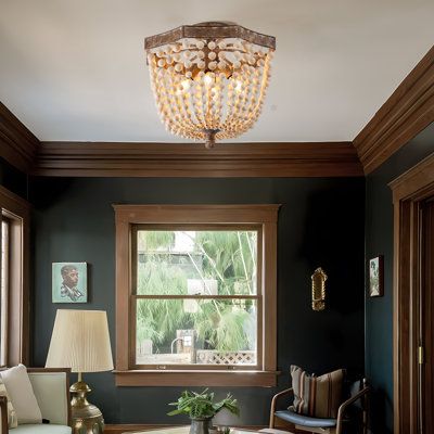 Add a touch of antique style to the decor of your modern home with the wood Bead Semi-Flushmount . The worn frame contains distinct, graceful curves and attaches a series of beads that flow downward and inward, connecting to a central pillar below. A set of four bulbs rest within, emitting a warm layer of light that accents with the beads as it spreads into the room. | Dakota Fields Chemise Wood Semi Flush Mount 16.1 H x 17.7 W x 17.7 D in brown / gray in Antique Copper | 16.1" H X 17.7" W X 17. Victorian Home Lighting, Exposed Wood Trim, Dark Painted Shiplap Walls, Modern Cabin Home Decor, Colonial Revival House Interior, Gothic Farmhouse Living Room, Bedroom Wood Trim, Wall Colors With Wood Trim, Moody Den