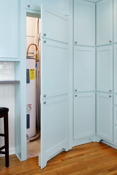 Faux cabinet doors hide a dedicated area for the water heater, formerly jammed into a closet shared with the pantry. There's even room for a new water softener as well. Hide Water Heater, Basement Decoration, Dream Basement, Basement Laundry Room, Basement Laundry, Basement Storage, Basement Makeover, Basement Ceiling, Laundry Room Storage