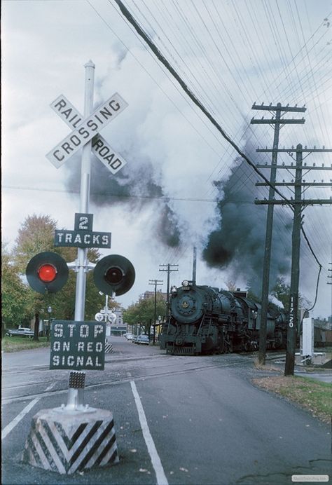 Baltimore & Ohio 2-10-2 6172 and an unidentified sister storm past new crossing signals at Park Street in Wapakoneta, Ohio., with a southbound freight sometime in the 1950s. Wapakoneta Ohio, Railroad Lights, Chessie System, Railroad Crossing Signs, Baltimore And Ohio Railroad, Railroad Crossing, Park Street, Abandoned Train, Railroad History