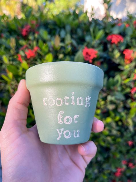 A little motivation can go a long way! Whether it's a friend, you, or your plants that need some encouragement - this pot will do the trick.  Dimensions: 3"h x 3"w For a long life, this pot has been soaked, sanded, and sealed with Plaid Clay Pot Sealer. For decoration, it was painted with matte acrylic paint and finished with Mod Podge Acrylic Sealer.  This pot is made from a terracotta material and has a drainage hole. While it has been sanded, some ridges may remain. Since terracotta pots are Small Terracotta Pot Painting Ideas, Painted Planter Ideas, Cute Plant Pots Painting, Garden Pot Painting, Mini Pot Painting Ideas, Painted Pots Diy Creative, Plants Pots Ideas, Small Pot Painting Ideas, Painting Plant Pots Ideas