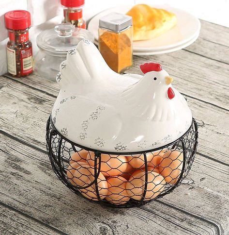 Keep your staying farm fresh on your counter or tabletop with this chicken and egg storage basket. The lid features an adorable white ceramic hen, perched atop a round metal chicken wire basket with a black powder-coat finish. Two handles have been adorned on the basket to allow you to carry this egg holder with ease. Find this Egg Storage Basket in the link below…  Find it HERE…    #Farm #EggStorage #Chicken #StorageBasket #Kitchen Chicken Wire Basket, Wire Egg Basket, Ceramic Chicken, Egg Container, Metal Chicken, Chicken Decor, Egg Storage, Cute Chickens, Farm Fresh Eggs