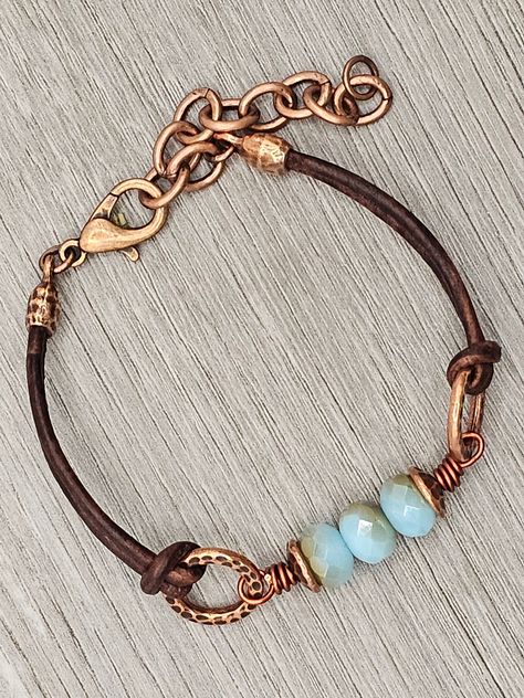 Czech Glass Aqua Opal Celsian  beads with antique copper accents on antique brown leather bracelet.  This bracelet has a size fit of approximately 7 inches to 7 1/2 inches. To keep beads, leather and all other components looking their best, avoid contact with water, lotions and perfumes. To access all other items in my shop, just hit the link here: https://www.etsy.com/ca/shop/KootenayLeatherRHS If you like jewelry, check out my other Etsy shop...it's jewelry for your door!  www.etsy.com/ca/shop Czech Glass Beaded Bracelet, Fall Jewelry Trends 2024, Bead Bracelets Diy, Glass Bead Jewelry, Czech Glass Bead Bracelet, Bohemian Chic Jewelry, Czech Beads Jewelry, Leather Cord Jewelry, Leather Jewelry Making