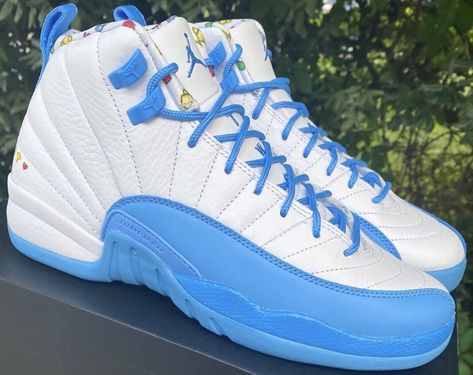 An exclusive colorway for kids, the Air Jordan 12 GS “University Blue” is similar to the Air Jordan 1 Low’s video game theme. And it’s most likely a part of something much larger. White, University Blue, and Lemon Venom are the colors of choice. The White leather base of this Air Jordan 12 features University Blue accents all over. The lateral heel and inner lining feature video game graphics, and the outsoles feature Lemon Venom to complete the look. On June 1st, select retailers an Video Game Graphics, Japanese Rising Sun, School Air, Sun Motif, Game Graphics, Jordans For Sale, Cheap Jordan Shoes, Jordan Retro 12, Pretty Shoes Sneakers