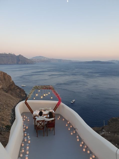 Greece Proposal Santorini, Wedding Private Dinner, Greece Proposal, Lots Of Candles, Hexagonal Table, Table With Chairs, Private Dinner, Themed Dinner, Dinner For 2