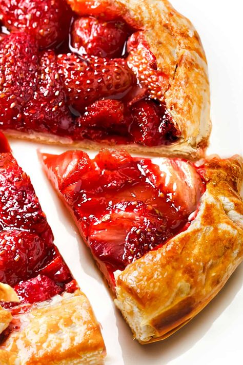 Fresh strawberries, puff pastry, and a hint of orange make a delicious Strawberry Galette. Served topped with vanilla ice cream or whipped cream, this strawberry galette is sure to be a hit at your next dinner or gathering. Strawberry Puff Pastry Tart, Strawberry Cream Tart, Fruit Galette Recipes, Strawberry Recipes Vegan, Strawberry Galette Recipe, Fruit Galette Recipe, Galette Recipes, Strawberry Puff Pastry, Fresh Strawberry Desserts