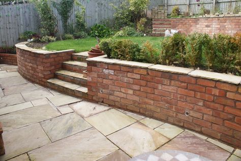 Brick Wall Landscape Ideas, Concrete Patio Between House And Garage, Brick Wall Capping Ideas, Small Courtyard Garden Ideas Brick Walls, Curved Brick Steps, Small Brick Wall Garden, Curved Garden Wall, Garden Wall Ideas Brick, Brick Wall Garden Ideas