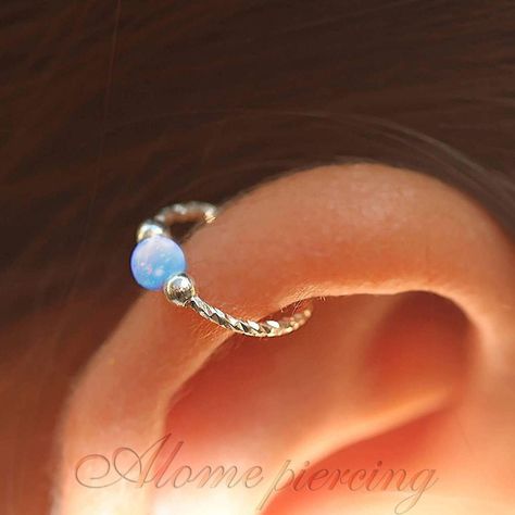 Sterling Silver Blue Opal Cartilage Earring ♥ Handmade 925 Sterling Silver hoop with 3mm dazzling Blue opal cartilage earring, can be used as helix hoop, helix hoop earring, Nose hoop, Cartilage earring. ♥ It is handmade out of 925 Sterling Silver Soft wire. ♥ The Size is 8 mm in Diameter, 20 Gauge with 3 mm Blue opal. ♥ Comfortable, lightweight, and easy to use, it is the most common size for cartilage earrings, please make sure it is the right size for you. ♥ Also Available In 3 additional Opal bead colors - pink, green, and white, please visit my shop. Measurements: ♥ Size Available: 0.3Inch - 8 mm Hoop Diameter. ♥ Gauge (Thickness of the wire): 0.8mm - 20 gauge Note: To put it on please twist the hoop sideways and slide it in, after it is in close it back and align it (instruction insi Blue Piercings Ear, Silver Helix Earrings, Helix Piercing Ring, Hoop Cartilage Earrings, Opal Cartilage Earring, Helix Earrings Hoop, Helix Jewelry, Helix Piercing Jewelry, Helix Hoop