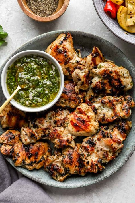 Charred, juicy and so delicious, these grilled Chimichurri Chicken Thighs make for the perfect dinner! Boneless chicken thighs are marinated in chimichurri, grilled up and served with another spoonful of that bright green sauce. This recipe is a summertime-must that is gluten-free, paleo and Whole30-friendly. Chimichurri Chicken Thighs, Charred Chicken, Chimichurri Chicken, Grilled Chicken Thighs, Perfect Dinner, Green Sauce, Paleo Chicken, Boneless Chicken Thighs, Boneless Chicken