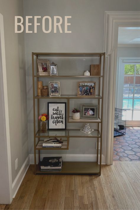 Modern bookcase with decorative items Bookcase With Picture Frames, Bookshelf With Family Photos, Baskets On Bookshelves, How To Display Family Photos On Book Shelves, Bookshelves With Picture Frames, Bookshelf With Picture Frames, Picture Frames On Bookshelves, Bookcase Photo Display, Bookshelves With Baskets