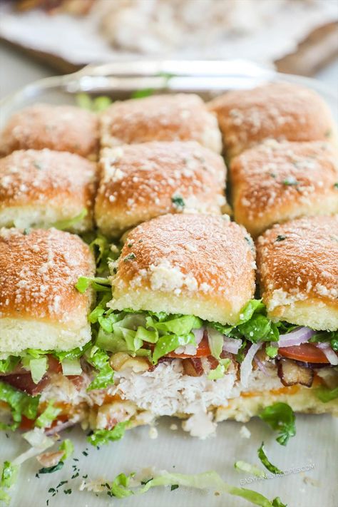 Feed a crowd with these easy turkey club sliders! Sweet Hawaiian rolls layered with turkey, smoky bacon, cheese, juicy tomatoes, and fresh lettuce make these sandwich-style sliders so good. Best of all, they’re really easy to make, simple enough for an easy family meal but also scalable to feed a crowd. Level up your slider game with these fun and fresh turkey sliders! Turkey Sliders Recipes, Turkey Club Sliders, Club Sliders, Crowd Meals, Sliders Recipes Turkey, Hawaiian Roll Sandwiches, Sweet Hawaiian Rolls, Luncheon Recipes, Sliders Easy