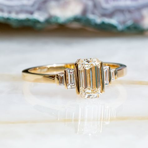 Beautiful Art Deco Engagement set with 1.11 carat of Emerald Cut cut diamond mounted in 14K Yellow gold.   Vintage Bars on top of Emerald cut & Baguettes, with Diana Rafael's light performing diamonds, makes a stunning ring, you won't ever take off!  Setting -Total Carat Weight: 1.11 carat -14K YellowGold -Size: Resizable - any size is availzble! Ask us!  -Certificate Of Authenticity Included  Main Diamonds: -Emerald Cut  -0.94 Carat -Color: G -Clarity: VS1 (Enhanced) -Cut:  Cut -Dimensions: 7.25 x 4.20  *Clarity Enhanced *Processing time* Unbeatable processing time of 3-5 business days! - custom orders is 5-7 Business days. *Shipping** We ship with FedEx Express shipping! Most items are delivered within 48-96 hours! ------------------------------------------------------------------------- Vintage Engagement Rings Unique 1920s Diamond, 3 Stone Art Deco Ring, Antique Bezel Ring, Vintage Emerald Cut Engagement Ring Set, Bar Set Engagement Ring, Antique Emerald Cut Ring, Baguette Emerald Engagement Ring, Vintage Wedding Rings Emerald Cut, Emerald Cut Engagement Ring Art Deco