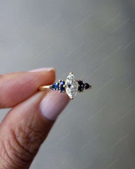 "★ RING INFORMATION ★ ------------------------------------------------------------------- ★ MAIN STONE ➺ SHAPE  :- Marquise cut Moissanite ➺ Weight :- 1.0 ct ( 10 x 5 MM )  ➺ Color :- colorless /white ➺ VVS Clarity ------------------------------------------------------------------- ★ SIDE DIAMOND  ➺ SHAPE  :-Pear And Round Sapphire   ➺ Weight :- 0.80 CT  ➺ Color :- Blue ➺ VVS Clarity  ------------------------------------------------------------------- ★ BAND  ➺ BAND WIDTH  :- 2.0 MM ➺ BAND THICK Diamond Ring With Sapphire Side Stones, Marquise Diamond And Sapphire Ring, Marquise Engagement Ring With Sapphires, Diamond And Sapphire Engagement Ring Gold, Engagement Rings Diamond And Sapphire, Engagement Ring Sapphire Side Stones, Blue Marquise Diamond Ring, Marquise Sapphire Ring, Sapphire Marquise Engagement Ring