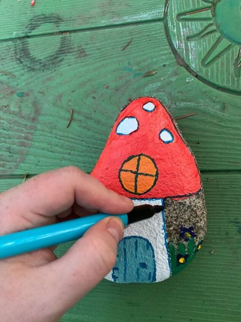 Learn how to paint a fairy house on a garden rock. This adorable fairy house will look great in your garden propped up next to a tree trunk. Add a touch of whimsy to your outdoor space with this fun painted rock craft. This painted rock craft is so easy to do and kids of all ages will have fun making them. I’m not sure what it is about painting rocks but it seems to be a universal craft that all kids love to do. Plus it’s pretty much free- all you need is rocks from the garden and a li… Mercury Glass Lighting, Flat Marbles, Mini Pine Cones, Cat Patio, Rainy Day Crafts, Cone Trees, Bird Houses Painted, Guest Bedroom Decor, Halloween Lanterns