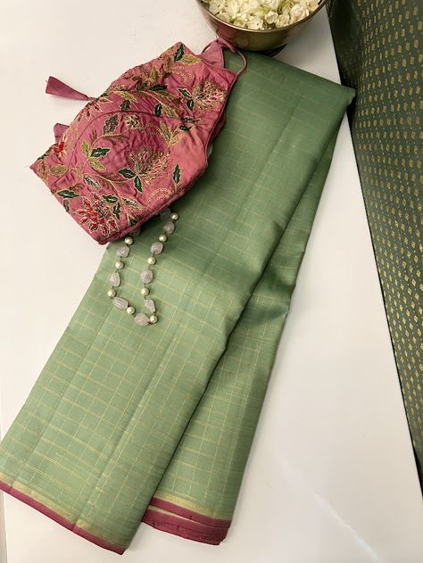 Our signature color combination, cardamom green and pink, finally debuts in the Charita style. Sink your eyes into this pure handloom kanchipuram silk saree with pure zari checked body with pink accents and witness how simplicity and opulence seamlessly merge in this exquisite drape. The pink and zari selvedge and zari striped pink pallu are the perfect accents to the cardomom green body. Pick one of very many of our blouses to pair beautifully with it or use the pink blouse that comes with the saree, either way, you are gaunrateed a stunning look. Different Colour Combinations In Sarees, Pink Blouse Green Saree, Green Silk Saree Contrast Blouse, Saree And Blouse Color Combinations, Green Contrast Color Combinations, Color Contrast Combination, Saree Colour Combination, Saree Pallu Design, Sarees Combination