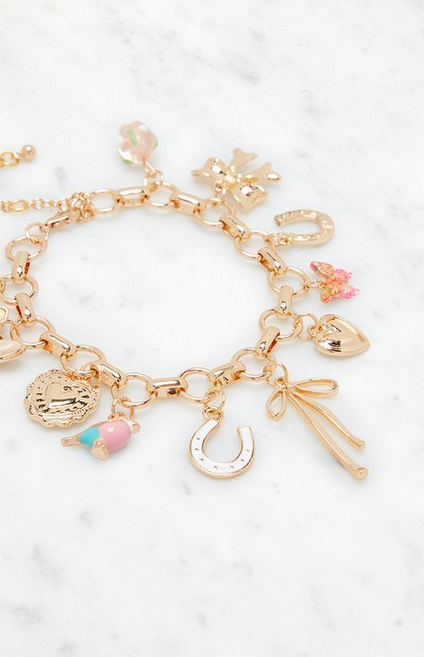 Add a touch of personality to your look with the Pink Charm Bracelet from LA Hearts. Featuring a chunky chain adorned with various charms, including dainty bows and butterflies, this bracelet is perfect for adding a playful elegance to any outfit.   	Lobster clasp closure 	Chunky chain 	Various charms Friendship Bracelets Charms, Gold Bracelet With Charms, Coquette Charm Bracelet, Christmas Wishlist Ideas Aesthetic, Diy Charm Bracelet Ideas, Charm Bracelet Ideas, Cute Charm Bracelets, Charm Bracelet Aesthetic, Pink Charm Bracelet