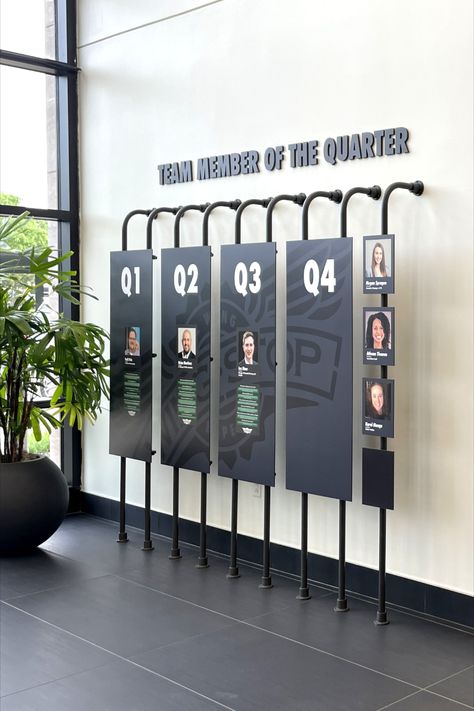 Photo shows large panels held up with piping. The panels are magnetic so the photos of the employees can be changed out every quarter. Employee Wall Display, Wall Timeline Design, Employee Photo Wall, Awards Display Wall, Library Bus, Conference Display, Board Room Design, Employee Branding, Exhibition Board Design