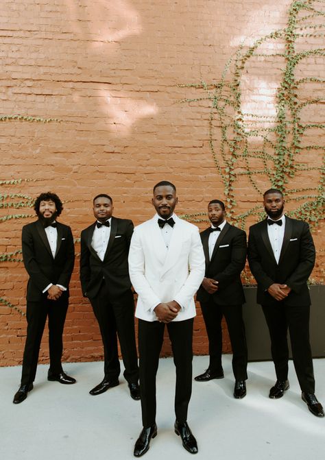 Classy, Simple, and Monochromatic Wedding | Junebug Weddings Groomsmen Attire Black, Groomsmen Black, White Tuxedo Wedding, Black Tuxedo Wedding, Groom Tuxedo Wedding, Monochromatic Wedding, White Wedding Suit, Groom And Groomsmen Suits, Black And White Wedding Theme