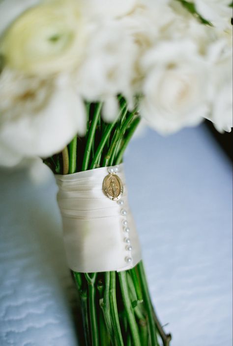 Bridal bouquet wrapped in doubleface cream satin ribbon fashioned with pearl head pins. The miraculous medal, a beautiful heirloom from the brides grandmother,is pinned to the ribbon for "something old". Ribbon Wrapped Bouquet, Ribbon Around Bouquet, Bridal Bouquet Wrap, Bridal Bouquet Ribbon, Elizabeth Ann Seton, Bridal Bouquet Flowers, Ribbon Bouquet, How To Wrap, Catholic Wedding