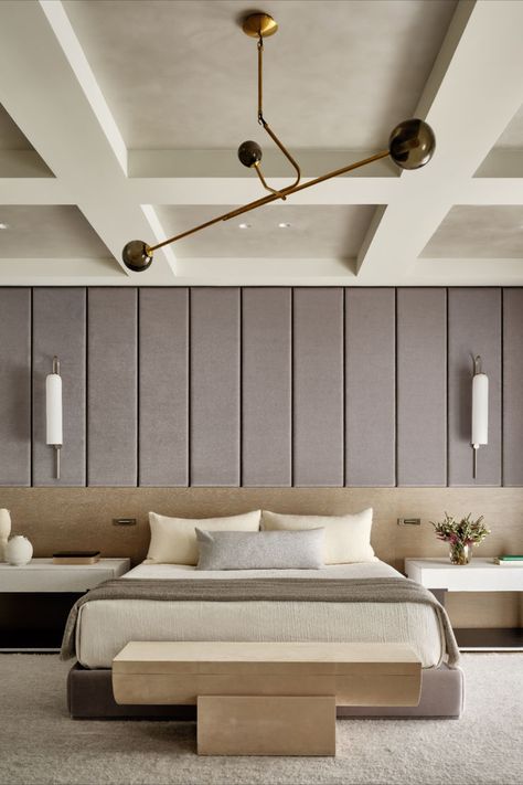 Primary bedroom; custom bed; upholstered walls; coffered ceiling; modern minimal; Workshop/APD transformed this exceptional double-wide Upper East Side townhouse’s interiors from a stylistically disjointed mash-up to a cohesive, inviting primary residence for a young family. Large-scale elements like a dangling, five-story custom chandelier at the core of its elegant central staircase bring drama and intrigue to a light, bright material and color palette. Coffered Ceiling Lighting, Modern Coffered Ceiling, Low Ceiling Bedroom, Upper East Side Townhouse, Custom Bed Frame, Wall Behind Bed, Coffered Ceiling Design, Workshop Apd, Townhouse Interior