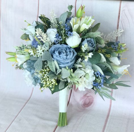 Bridal Bouquet 11-12 inches Bridesmaid bouquet 8 inches Small bridesmaid bouquet 6 inches This romantic bouquet not only looks fresh and realistic but will be a keepsake for a lifetime without the worries of wilting fresh flowers. The gorgeous bouquet was handmade in shades of dusty blue, steel blue, sage, ivory and white. Made with high quality silk peonies, garden roses, hydrangeas, spray roses, wild flowers, ranunculus, babys breath, seeded eucalyptus, fern and greenery. Stems are wrapped wit Dusty Blue Wedding Decorations Flowers, Flowers That Go With Blue Dresses, Boho Blue Bouquet, Dusty Blue Flowers Bouquet, Steel Blue Wedding Colors, Dusty Blue Bridesmaid Bouquet, Powder Blue Wedding Theme, Beach Wedding Bouquet Ideas, Dust Blue Wedding