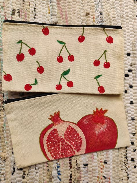 *Handpainted canvas pouches with pomegranate and cherries designs, perfect for gifts. *12x21cm ideal as a pencil case, accessories or makeup case. *Handpainted with acrylic, gouache and fabric medium* and finished with acrylic markers  *this should make the purse washable but gentle hand washing is recommended if necessary Pencil Case Painting Ideas Aesthetic, Pencil Case Design Diy, Cute Pencil Case Design, Drawing On Pencil Case, Pencil Case Design Ideas, Pencil Case Drawing Ideas, Makeup Bag Painting Ideas, Canvas Pencil Case Design, Pencil Pouch Painting Ideas