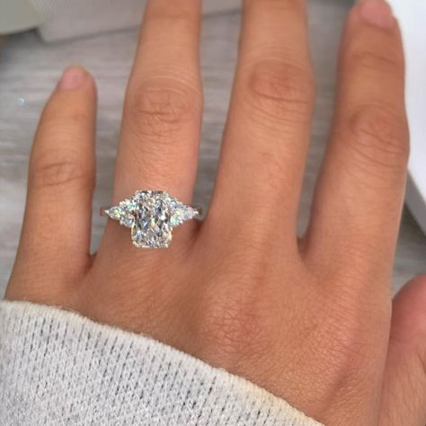 unique three stone engagement rings with accented diamonds. Elongated Radiant 3 Stone Engagement Ring, Radiant Halo Engagement Ring, Elongated Radiant, Radiant Engagement, Radiant Halo, 3 Stone Engagement Ring, Radiant Ring, Radiant Cut Engagement Rings, Radiant Engagement Rings