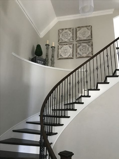 Decorate large high ceiling curved stairs shelf large entryway Curved Stair Wall Decor, How To Decorate A Curved Wall Entryway, Stair Shelf Decor, Staircase Ledge Decor Ideas, High Ceiling Stairway Decor, Curved Staircase Wall Decor, Entryway Ledge, Foyer Ledge, Foyer Shelf