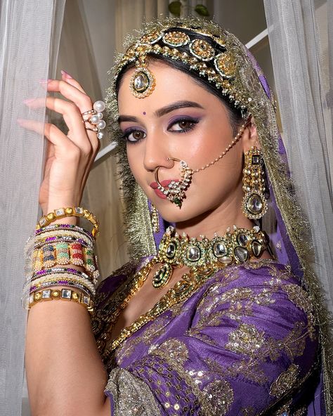 𝗣𝗿𝗲𝘀𝗲𝗻𝘁𝗶𝗻𝗴 𝗥𝗲𝗸𝗵𝗮 𝗠𝗮𝗻𝗴𝗮𝗹’𝘀 𝗕𝗿𝗶𝗱𝗲 💜 The Maharani Look—a celebration of heritage, power, and elegance. This timeless bridal look embraces minimalism, with makeup that highlights the natural beauty of the bride. The eyes are the focal point, adorned with a striking blend of purple and violet gradation, creating a bold yet graceful statement. Complemented by soft, pink nude lips, this look captures regal sophistication, perfect for the modern-day queen.👸 👑 (Bridal makeup, indore makeup artist, l... Maharani Bridal Look, Purple Lehenga Bridal, Maharani Look, Indian Makeup Looks, Purple Lehenga, Purple Saree, Nude Lips, Purple Eyeshadow, Indian Makeup