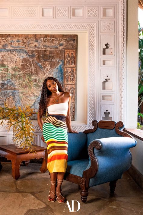 Whenever supermodel Naomi Campbell needs to unplug, she heads to her luxurious, airy villa in Malindi, Kenya. Here she poses in her entryway in front of a Bas-relief of Africa by local artist Armando Tanzini hanging on the wall. #NaomiCampbell #design #fashion #entryways #chair #armchair #Africa #kenya #wood #art #painting #villas Ancient Egyptian Cities, Kenyan Artists, Fashion Competition, Laura Bailey, Family Style Dinner, Art Partner, Poppy Delevingne, Sienna Miller, Naomi Campbell