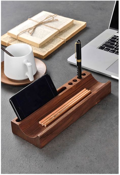 Organize your desk in style with the multifunctional wooden pen holder. Made with black walnut, it also doubles as a phone holder and storage tray. Keep everything you need within reach while adding a touch of elegance to your office. Material:Black WanlutSize:28cm(L)*9cm(W)*3.5cm(H) (1 inch=2.54cm) Woodworking Gift Ideas, Walnut Office, Diy Projects Wood, Desktop Ideas, Turned Pens, Wood Pen Holder, Wood Working Ideas, Wood Desk Organizer, Wooden Pen Holder