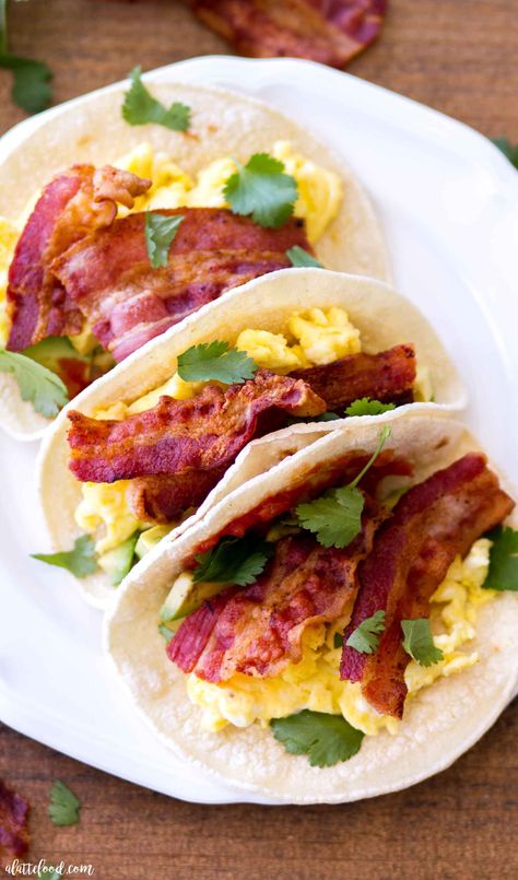 These Egg and Bacon Breakfast Tacos are full of hickory smoked bacon (Jimmy Dean® Bacon), fluffy scrambled eggs, salsa, cilantro, and avocado. Served on corn tortillas or flour tortillas, this breakfast taco recipe is sure to be an easy breakfast staple. This hearty breakfast recipe is perfect for Father’s Day, but easy enough to whip up any day of the week! easy egg tacos, how to make scrambled eggs, the best scrambled eggs Bacon Taco, Hearty Breakfast Recipes, Breakfast Tacos Recipe, Bacon Corn, Breakfast Taco, Egg And Bacon, Bacon Eggs Breakfast, Fluffy Scrambled Eggs, Chicken Roll