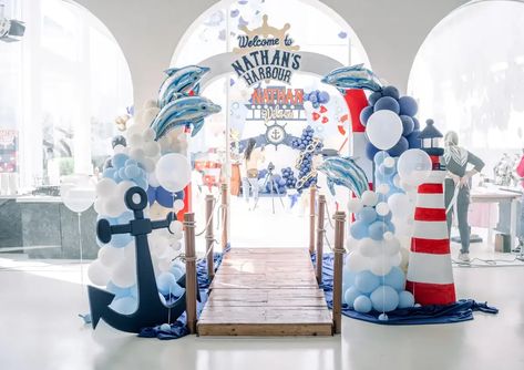 Nathan's First Sail-abration | CatchMyParty.com Nautical Theme Backdrop, Nautical Themed Party Backdrop, Sailor Theme Party Decorations, Sailor Party Ideas, Nautical Theme Decorations, Sailor Decoration Party, Ahoy Birthday Theme, Ship Birthday Party, Ship Party Decorations