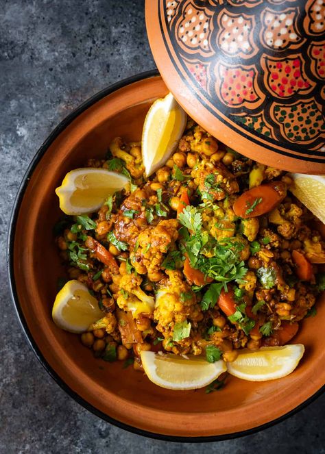 This recipe for vegetable tagine makes a hearty Moroccan dish with carrots, cauliflower, and chickpeas in a flavorful, aromatic stew. Moroccan Tagine Recipes Vegetarian, Vegetarian Tagine Recipes, Vegan Tagine Recipes, Moroccan Vegetarian Recipes, Tagine Recipes Vegetarian, Moroccan Appetizers, Morrocan Stew, Moroccan Vegan, Bohemian Recipes