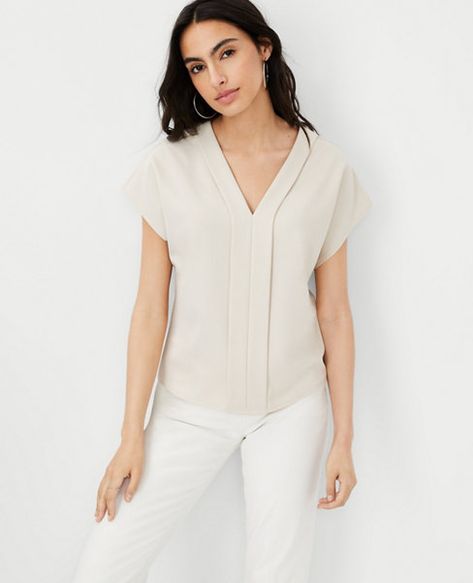 Flattering for day or night, our crepe V-neck top intrigues with clean lines and summer's prettiest palette. V-neck. Cap sleeves. Pleat front placket. Tan Blouse, Crepe Top, Blouse Outfit, Light Tan, V Neck Tops, Effortless Style, Ann Taylor, Cap Sleeves, Stylish Outfits