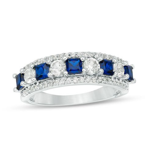 Elegant and alluring, this fashion ring is a must-have for your wardrobe. Created in cool 10K white gold, this splendid style features a row of five 3.0mm princess-cut lab-created bright blue sapphires alternating with four 3.0mm round lab-created white sapphires - all wrapped in shimmering diamond-lined stepped borders. Sparkling with 0.23 ct. t.w. of diamonds and a brilliant buffed lustre, this look is certain to attract attention. Blue 14k White Gold Ring With Vs Clarity, White Sapphire Promise Ring In 14k Gold, 20 Anniversary, Opal Engagement Ring Rose Gold, Diamond Ring Princess Cut, Diamond Cluster Engagement Ring, Anniversary Ideas, Princess Cut Rings, Sapphire Wedding