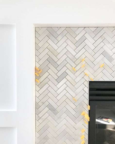 Carrara marble herringbone tile on a fireplace surround. Herringbone Tile Fireplace, Herringbone Fireplace, Fireplaces Layout, Craftsman Fireplace, Tall Fireplace, Life On Virginia Street, Wooden Fireplace, Fireplace Tile Surround, Paint Fireplace