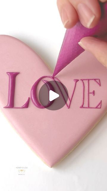 Honey & Lou Baking | Eileen on Instagram: "Sending this small dose of LOVE out into the world on another dark and chilly Winter evening. Who’s ready for Spring?! 🙋🏻‍♀️ Royal icing tutorial, tips and tricks, Valentine, Valentine’s Day, heart, lettering, pink love, decorating sugar cookies, holiday art #RoyalIcing #DecoratedCookies #CookieArt #heartcookie #rosecookie #valentinecookie #decoratingtips #decoratingtricks #RoyalIcingTips #royalicingtricks #buzzfeedtasty #CreativeBaking #CookieDesign #HandDecorated #EdibleArt #CookieInspo #InstaCookies #CookieVideo #howtodecoratecookies #satisfyingvideos #cookielover #cookiegram #cookiesofinstagram #thebakefeed #designercookies #cookiedecorator #cookieartist #sugarcookiedecorating #sugarcookies #sugarcookiesofinstagram" Royal Icing Lettering, Heart Shaped Cookies Decorated, Royal Icing Tutorial, Heart Cookies Decorated, Heart Lettering, Decorating Sugar Cookies, Cookie Gram, Valentine Cookies Decorated, Heart Sugar Cookie