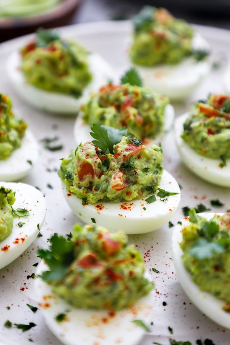 These guacamole deviled eggs are made with mashed avocado, cilantro, jalapeno & a touch of lime juice! They're everything you love about guacamole turned into a festive deviled egg appetizer! Maple Bacon Brussel Sprouts, Appetizers For Christmas, Best Superbowl Food, Egg Appetizer, Healthy Deviled Eggs, Guacamole Deviled Eggs, Guacamole Ingredients, Air Fryer Wings, Peeling Hard Boiled Eggs