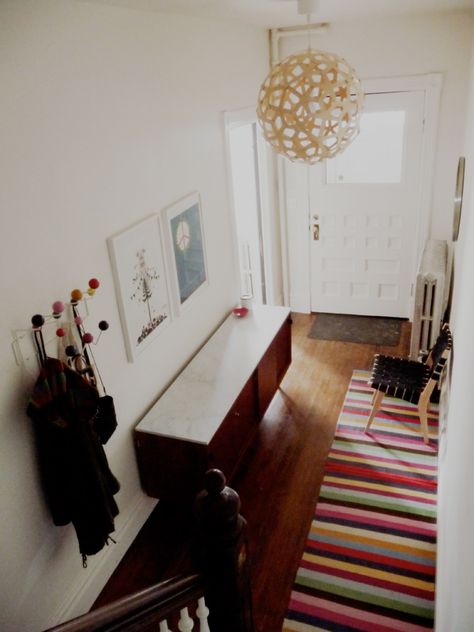 colorful entry Funky Pendant Lights, Eames Hang It All, Concrete Deck Blocks, Hang It All, Concrete Deck, Narrow Entryway, Runner Rug Entryway, Entry Hallway, Hall Rugs