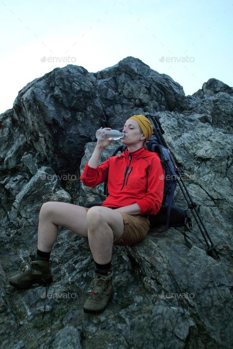 female hiker drinking water by PaulSchlemmer. causian female hiker sitting on a rock next to her backpack drinking water out of a bottle #Sponsored #water, #PaulSchlemmer, #drinking, #female Female Hiker, A Rock, Drinking Water, Trekking, How To Draw Hands, Stock Photos, Drinks, Water