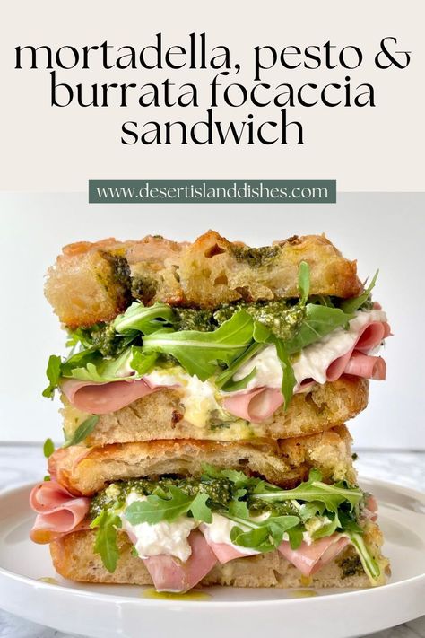 This easy focaccia sandwich has crisp pesto focaccia, pesto, burrata, mortadella, rocket and a homemade garlic confit aioli. Pesto Focaccia Sandwich, Sandwiches Birthday Party, Focaccia Panini Sandwiches, Pesto Sourdough Sandwich, Faccocia Sandwich, Best Deli Sandwiches, Focaccia Sandwich Recipes, Italian Focaccia Sandwich, Mortadella Sandwich Recipes