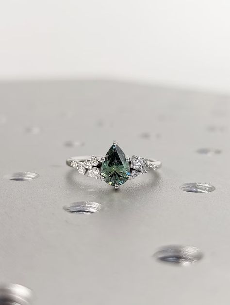 MAIN STONE
Type: Braverman Moissanite
Cut: Pear
Color: Green
Clarity: VVS

#Pear #Cut #Green #Moissanite #Ring #Vintage #Moissanite #Engagement #Ring #Solid #Gold #Unique #Snowdrift #6 #Prongs #Engagement #Ring #Diamond #Wedding #Ring #18k #white #gold #ring #personalized #ring #alternative #ring #anniversary #ring #bridal #ring #cluster #ring #dainty #ring #engagement #gifts #engagement #rings #gift #for #her #promise #ring #for #her #rose #gold #snowdrift #ring Silver Band Engagement Ring Unique, Silver Engagement Rings Diamond, Green Gem Wedding Ring, Cottagecore Wedding Ring Silver, Green Stone Engagement Ring Silver, Simple Silver Engagement Rings Unique, Silver Engagement Rings Colored Stone, Emerald And Silver Engagement Ring, Earthy Engagement Rings Silver