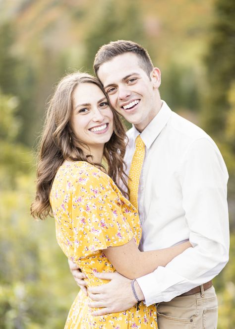 beautiful couple subtle matching outfits semi formal couple outfit inspiration adorable yellow dress couple hugging and facing the camera pose inspiration glowing couple bright warm lighting professional engagement picture goals easy womens hair do for medium length hair outfit goals #fallengagement #engagementsession #fallcolors #semiformal #photoshoot #outdoor #woods #beautifulcolors #love #couplegoals Be Happy Single, Hugging Pose, Poses Lighting, Formal Engagement Photos, Happy Single, Casual Engagement Photos, Wedding Announcements Photos, Professional Photoshoot, Northern Utah