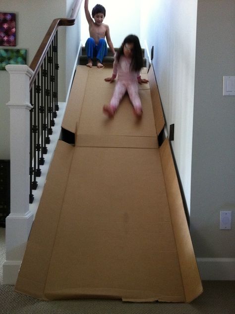 Fun thing to do with a refrigerator box and stairs!!! Love to do this myself Cardboard Box Fort, Cardboard Boxes Kids, Stair Slide, Diy Slides, Carton Diy, Cardboard Box Crafts, Cardboard Toys, Diy Kids Toys, Indoor Fun