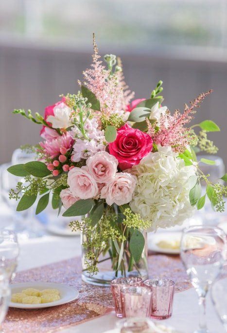 a vibrant wedding centerpiece of white, light and hot pink blooms, berries and foliage is lovely and chic Centerpiece Pink Flowers, Pink Floral Table Arrangements, Pink Roses And Hydrangea Bouquet, Light Pink Floral Arrangements, Light Pink Wedding Centerpieces, Pink Floral Arrangements Wedding, Light Pink Flower Arrangements, Shades Of Pink Wedding Flowers, Blush Pink Flower Arrangements