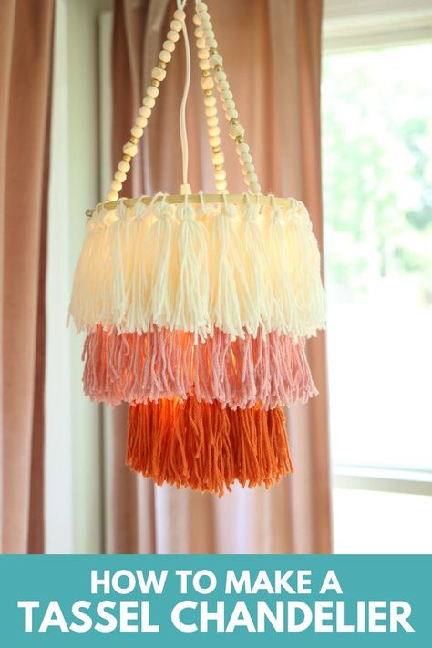 Glam up your space with this gorgeous boho-inspired tassel chandelier. Customize the size of your chandelier and your yarn colors to your decor. This hanging light would be perfect in a baby nursery, a teen bedroom, over a dining table, or in your favorite cozy corner. Diy Nursery Light, Diy Tassel Lampshade, Tassle Lamp Shades, Boho Ceiling Hanging Decor, Diy Boho Chandelier Ideas, Diy Yarn Chandelier, Diy Boho Hanging Light, Diy Tassel Chandelier, Crib Chandelier