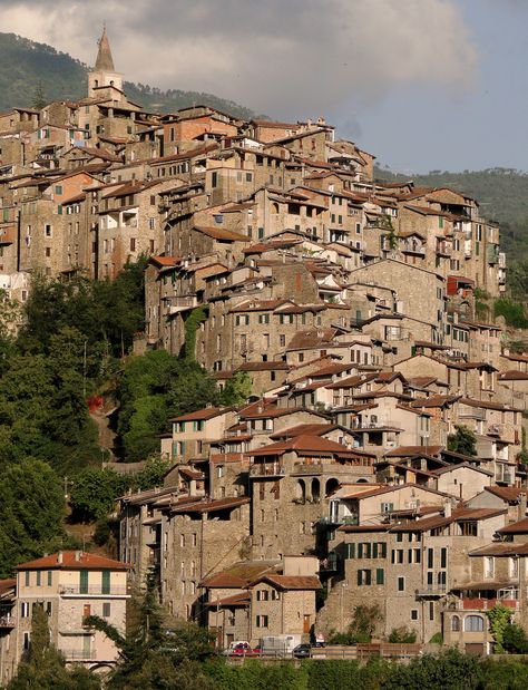 There is a ‘secret’ fairytale valley in Italy that not many people know about, where hill towns are piled on top of one another and tumble vertically down mountains. Apricale is the sho… Italian Hill Towns, City On A Hill, Architecture Photography Buildings, Italian Town, Hill City, Mountain City, Italian City, Down Town, Italian Village